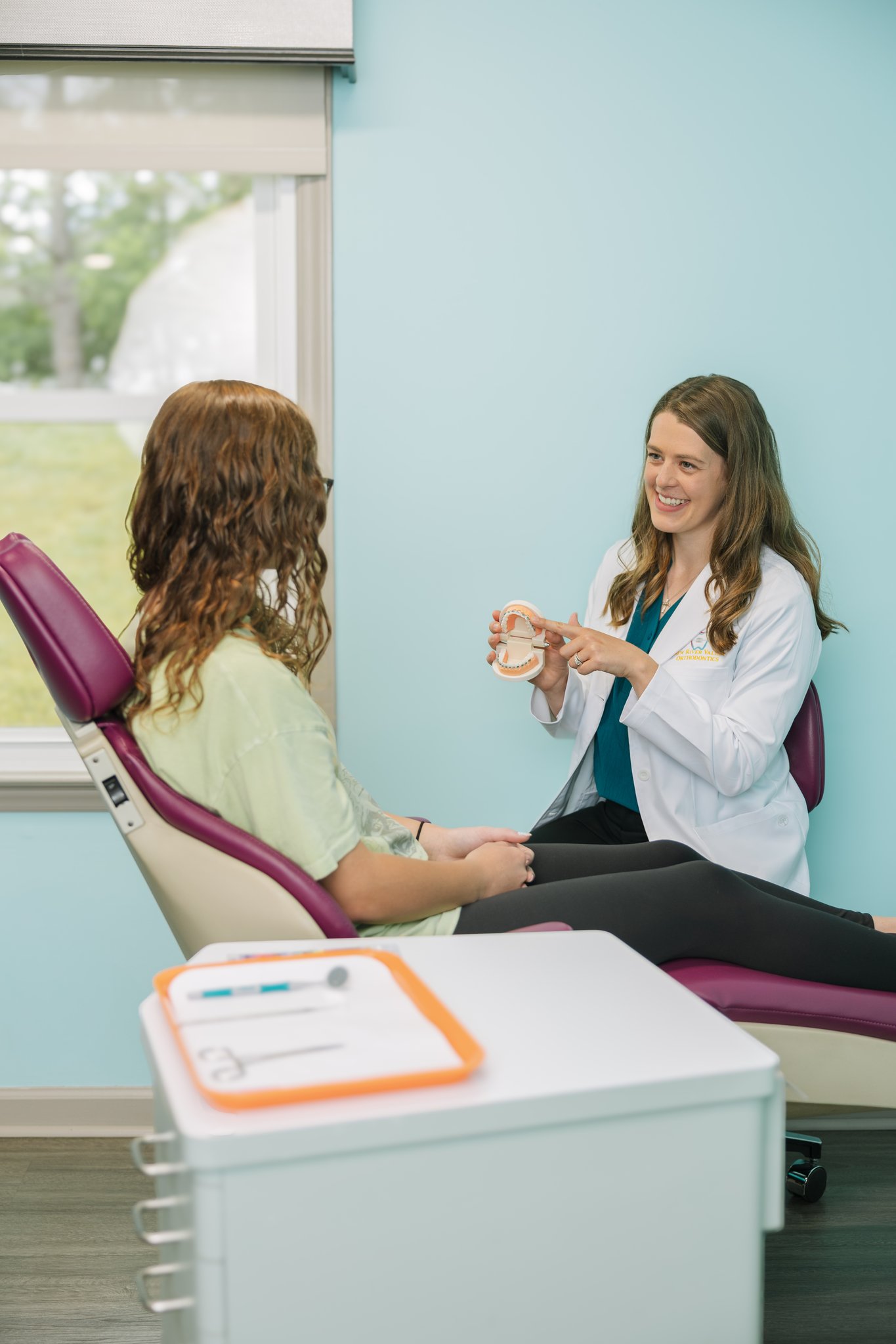 Orthodontist explaining braces for a patient in Radford, VA