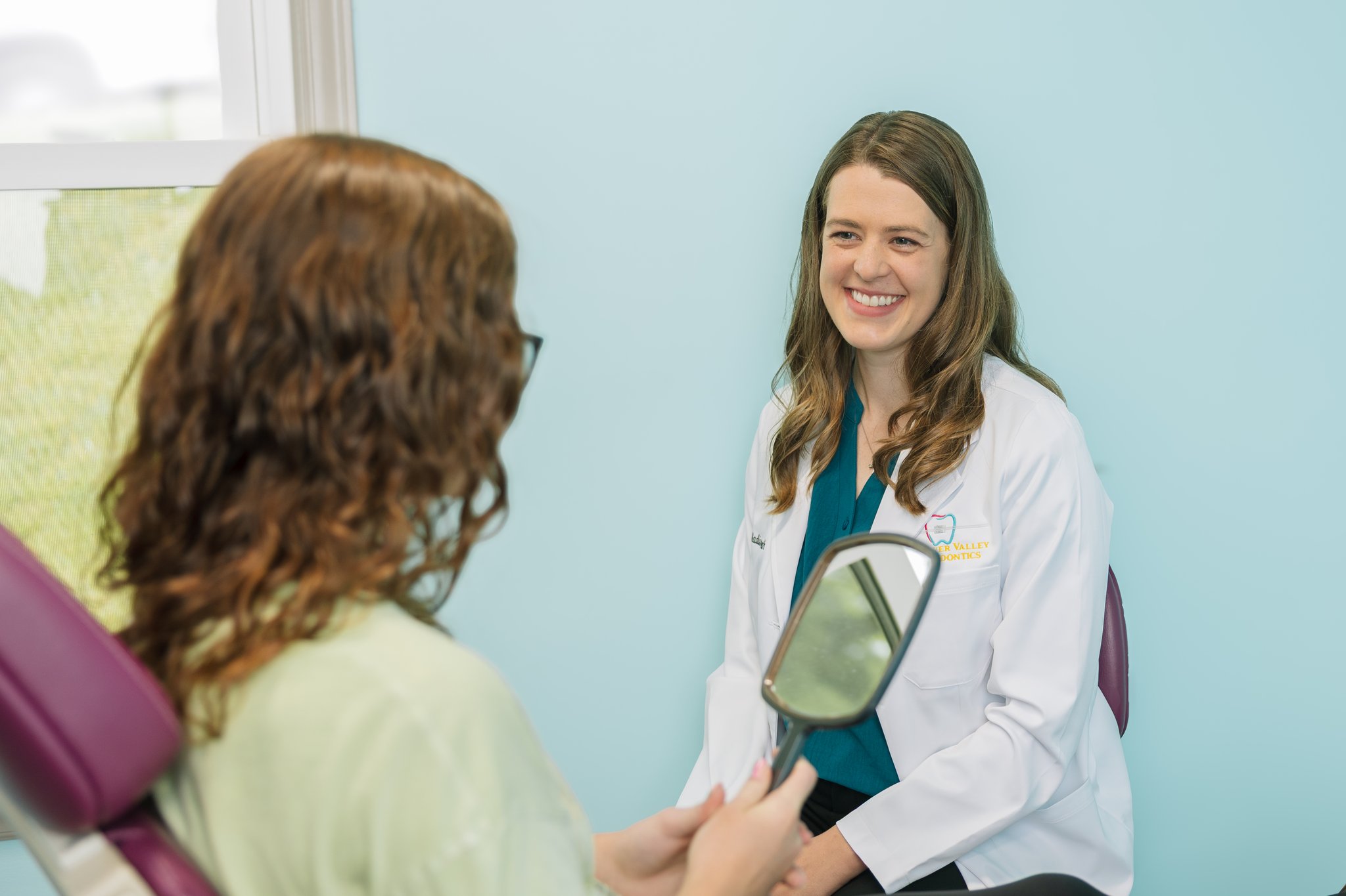 Orthodontist adjusting retainers for a patient in Radford, VA