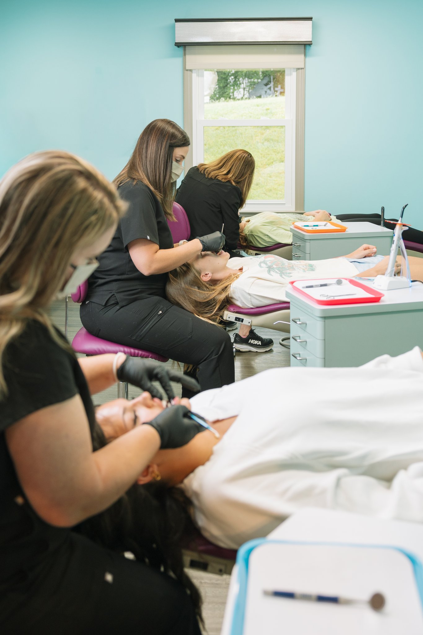 Orthodontic assistant with patients at New River Valley Orthodontics